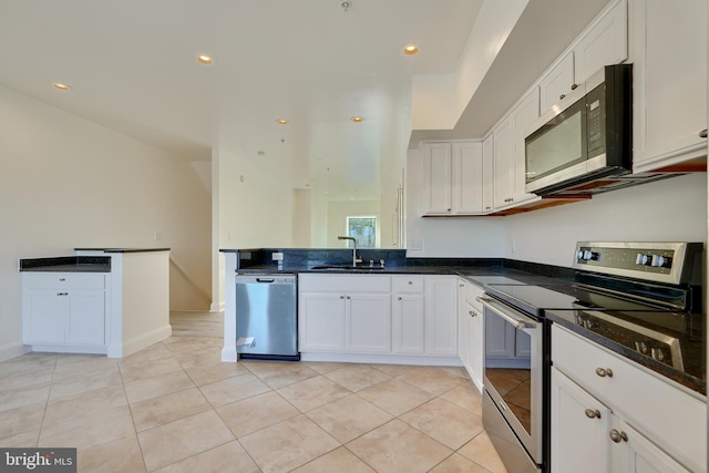 kitchen with white cabinets, light tile patterned flooring, sink, and stainless steel appliances