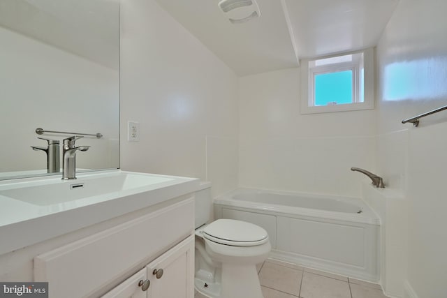 bathroom featuring tile patterned floors, a bathing tub, vanity, and toilet