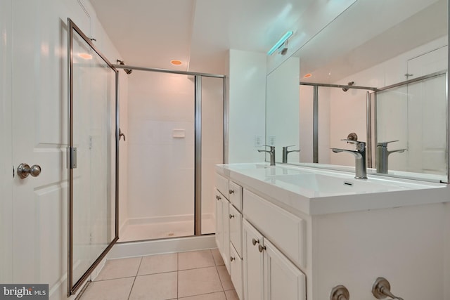 bathroom with vanity, tile patterned floors, and walk in shower