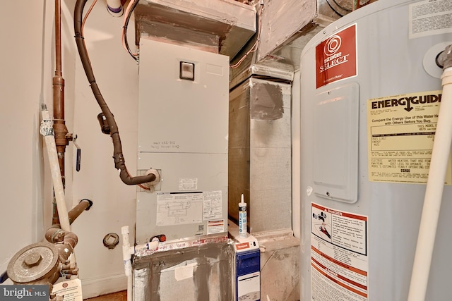 utility room featuring heating unit and water heater