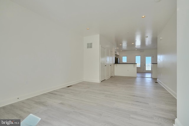 unfurnished living room with light hardwood / wood-style floors