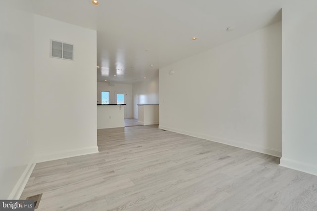 spare room with light hardwood / wood-style flooring