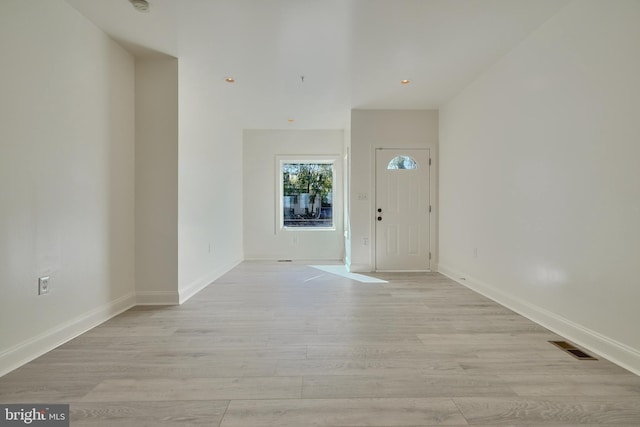 foyer entrance with light wood-type flooring