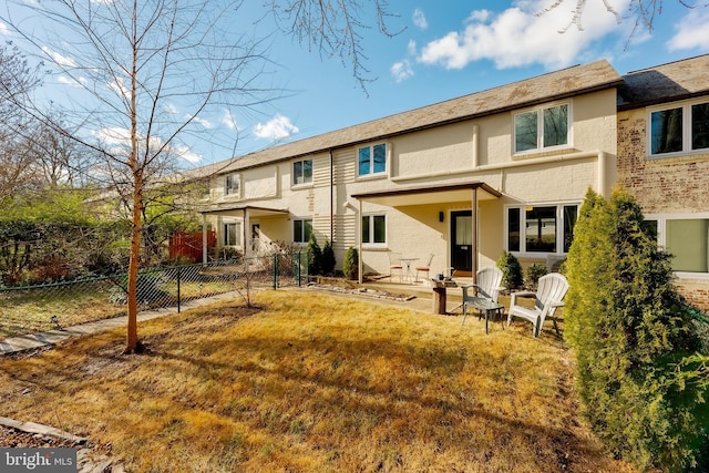 back of house featuring a yard and a patio