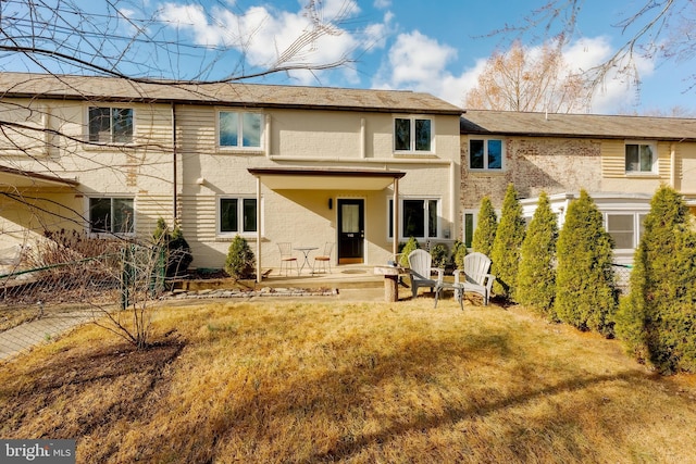 back of house with a lawn