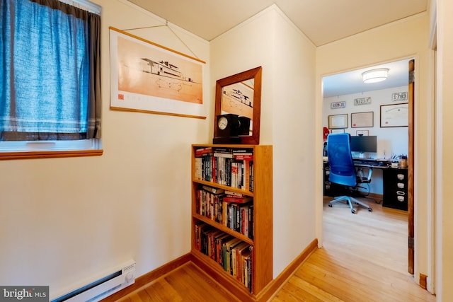 hallway featuring wood-type flooring and a baseboard radiator