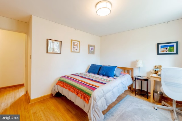 bedroom with hardwood / wood-style flooring