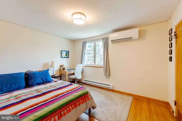 bedroom with light hardwood / wood-style floors, an AC wall unit, and baseboard heating