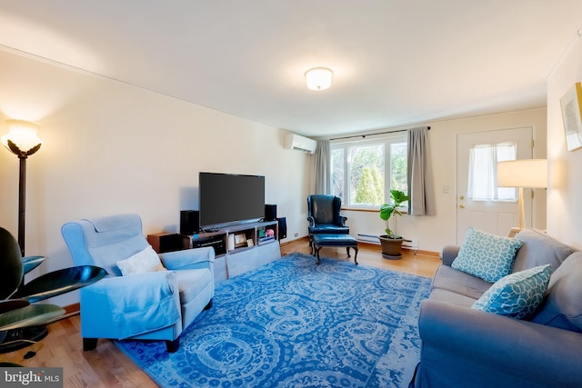 living room with a wall mounted air conditioner and hardwood / wood-style flooring