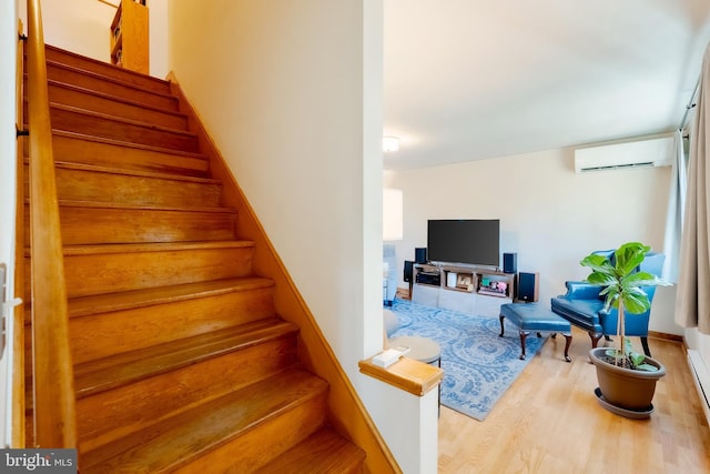 stairs with wood-type flooring and an AC wall unit