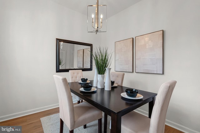 dining room featuring dark hardwood / wood-style flooring and a chandelier