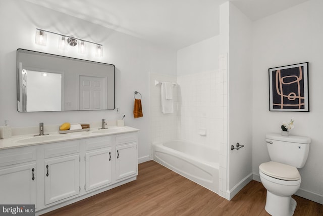 full bathroom with toilet, vanity, bathtub / shower combination, and hardwood / wood-style flooring