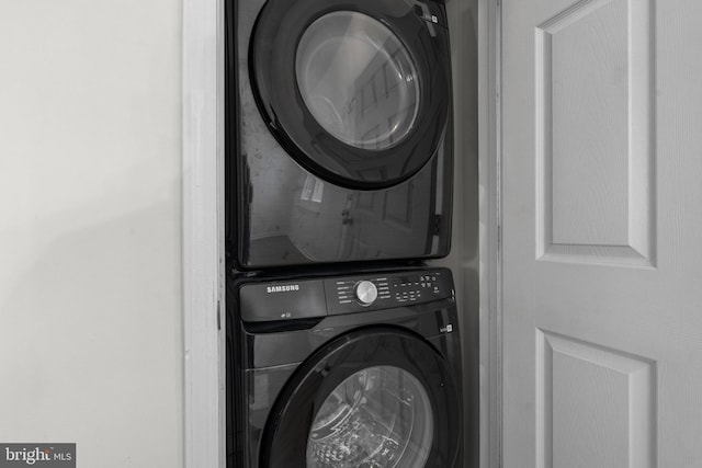 clothes washing area with stacked washer and dryer