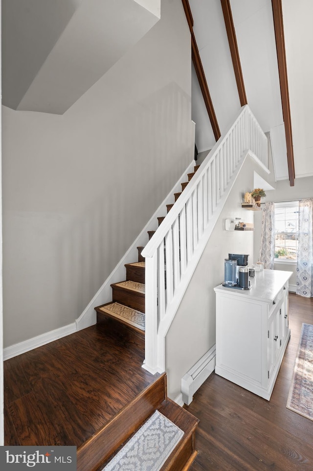 stairway with hardwood / wood-style flooring, beam ceiling, and high vaulted ceiling