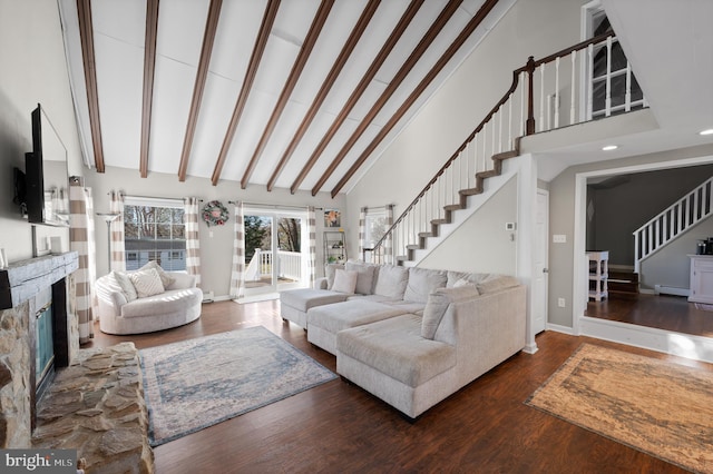 living room featuring dark hardwood / wood-style flooring, high vaulted ceiling, beamed ceiling, a baseboard heating unit, and a fireplace