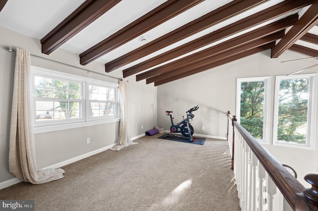 exercise room with carpet flooring, plenty of natural light, and vaulted ceiling