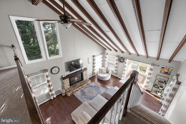 living room with ceiling fan, a fireplace, lofted ceiling with beams, and dark hardwood / wood-style floors