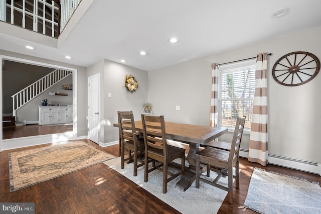 dining room with dark hardwood / wood-style flooring and baseboard heating