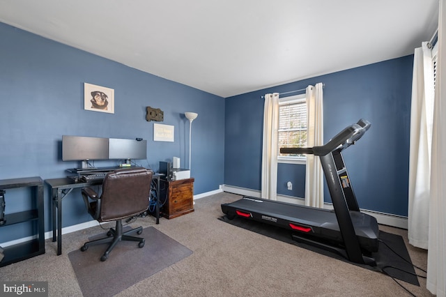 carpeted office space featuring a baseboard radiator