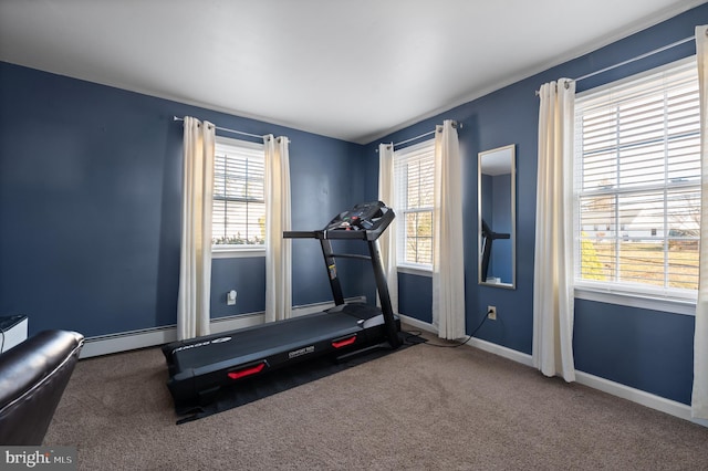 exercise area featuring carpet and a baseboard radiator