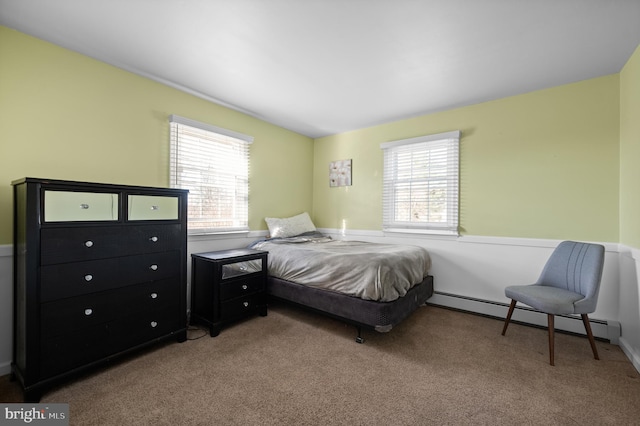 bedroom with light colored carpet and a baseboard heating unit