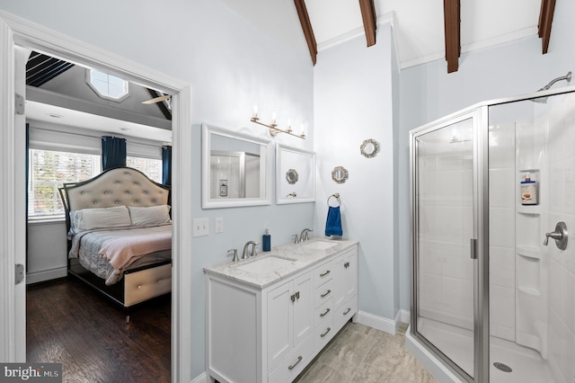 bathroom featuring vanity, wood-type flooring, vaulted ceiling with beams, and an enclosed shower