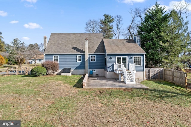 back of house featuring a patio and a lawn