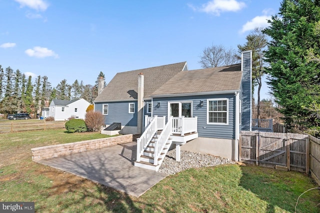 rear view of property with a yard and a patio