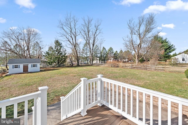 deck with a lawn and an outbuilding