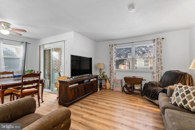 living room featuring light wood-type flooring and ceiling fan