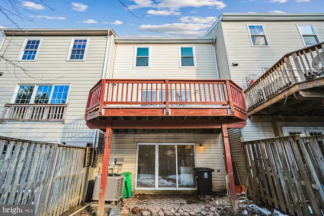 rear view of property featuring central AC