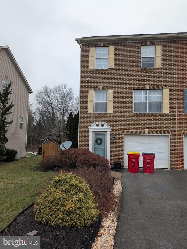 view of front of home with a garage and a front lawn