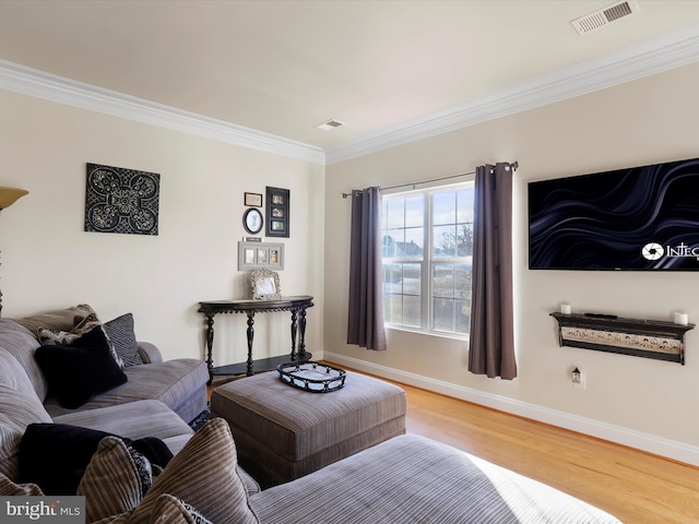 living room featuring crown molding and hardwood / wood-style flooring