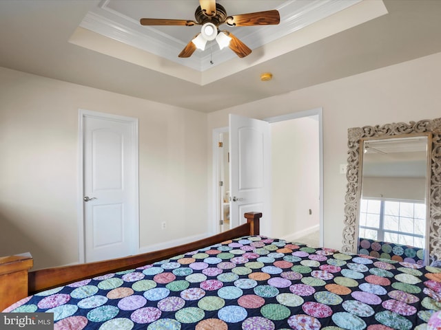 bedroom featuring a raised ceiling, ceiling fan, and crown molding