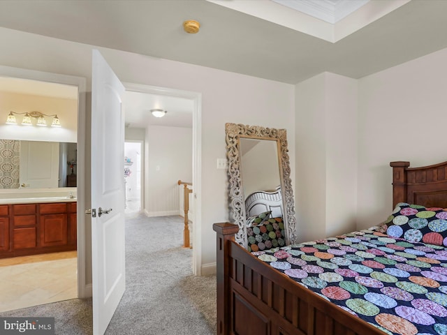 bedroom with light carpet and ensuite bath