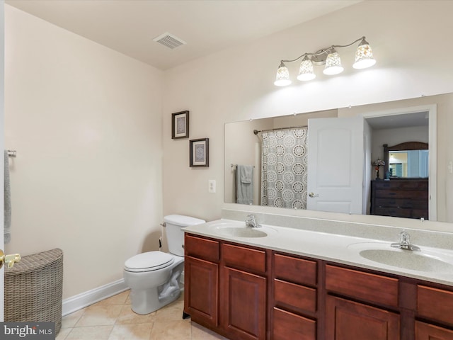 bathroom with tile patterned floors, vanity, and toilet