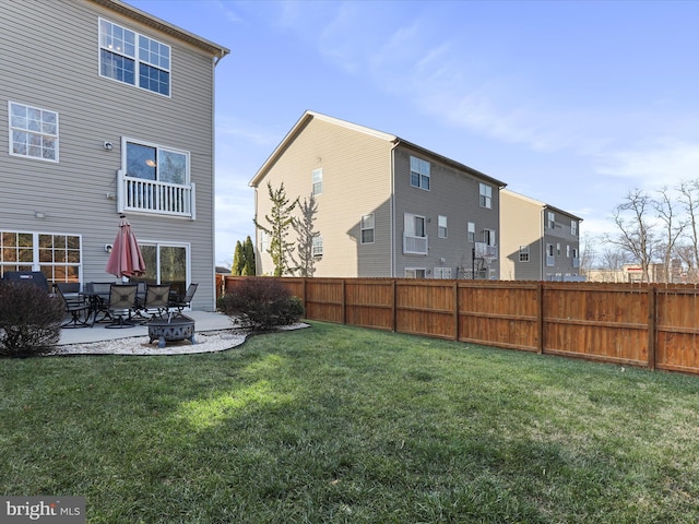 back of house featuring a yard and a patio