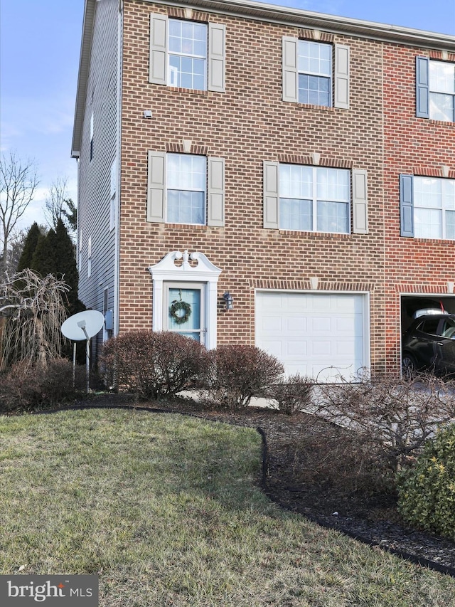 view of front of house with a front yard and a garage