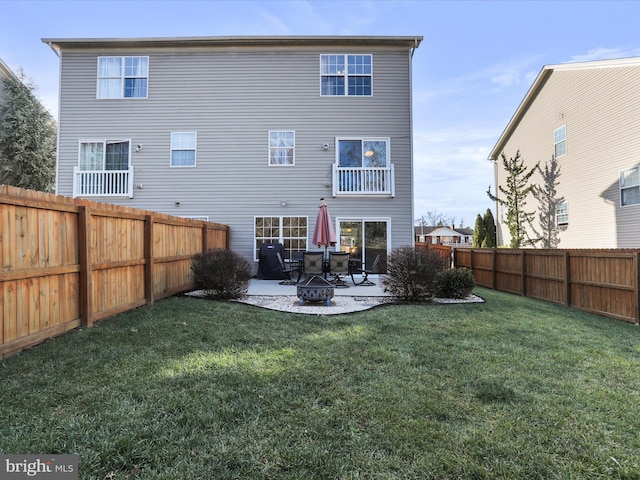 rear view of property featuring a yard and a patio