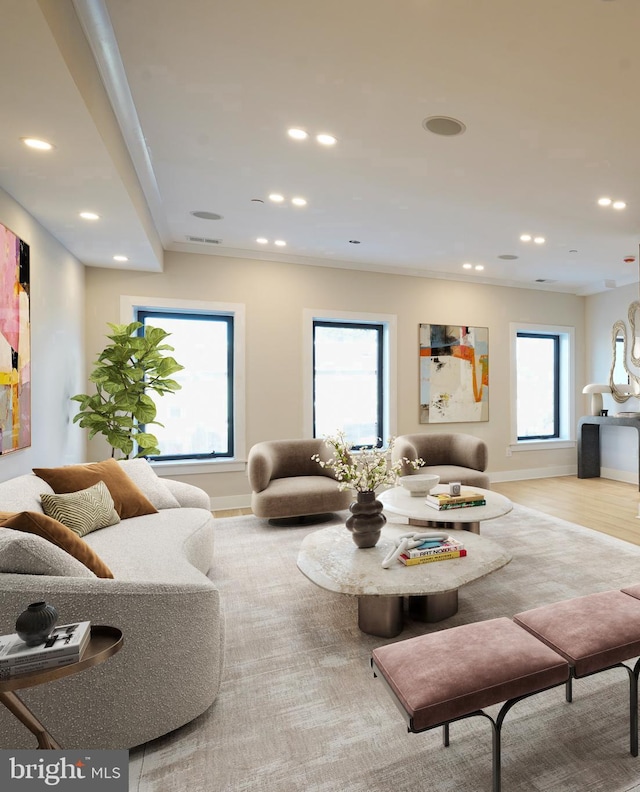 living room featuring baseboards, light wood-style floors, a wealth of natural light, and recessed lighting