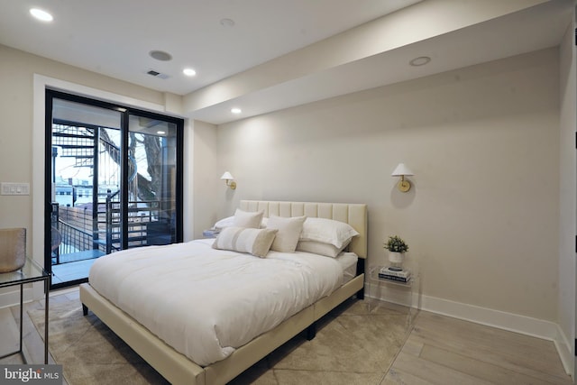 bedroom with access to exterior and wood-type flooring