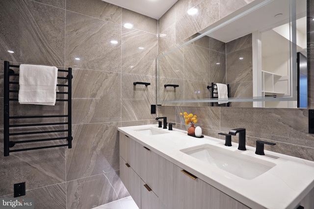 bathroom featuring radiator, backsplash, and vanity