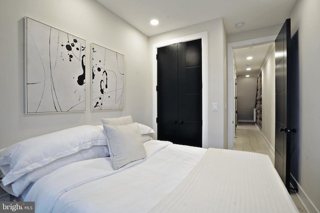 bedroom with a closet and light hardwood / wood-style floors