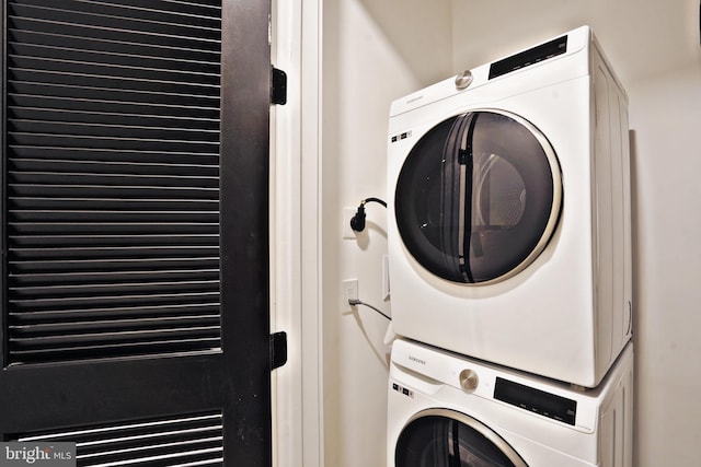 washroom featuring stacked washer / dryer