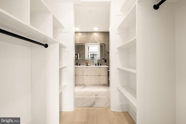 spacious closet featuring light wood-type flooring