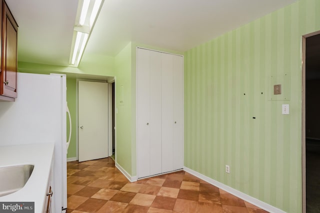 kitchen featuring sink and white refrigerator