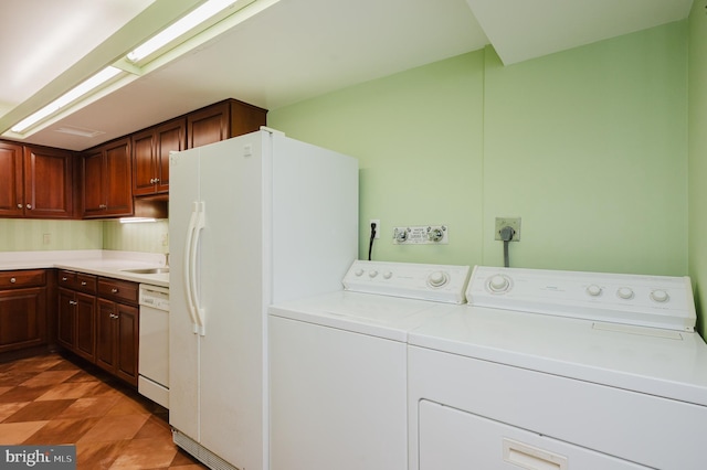 laundry area featuring washer and clothes dryer and sink