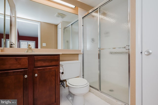 bathroom with vanity, toilet, and a shower with door