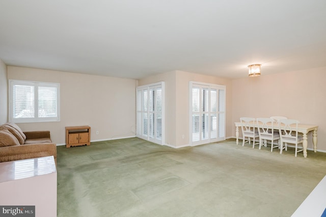 living room featuring a wealth of natural light and carpet