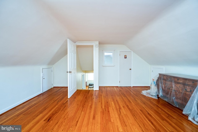 bonus room featuring light hardwood / wood-style floors and lofted ceiling